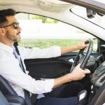stylish-businessman-wearing-sunglasses-driving-car_23-2148164241