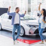 happy-couple-car-dealership_23-2148130150
