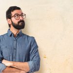 young-hipster-man-thinking-white-background_1368-6185