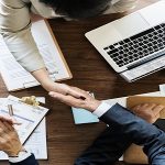 Business people shaking hands together
