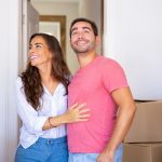 Cheerful excited couple moving into new house