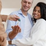 happy-couple-receiving-the-keys-to-their-new-home-from-the-realtor